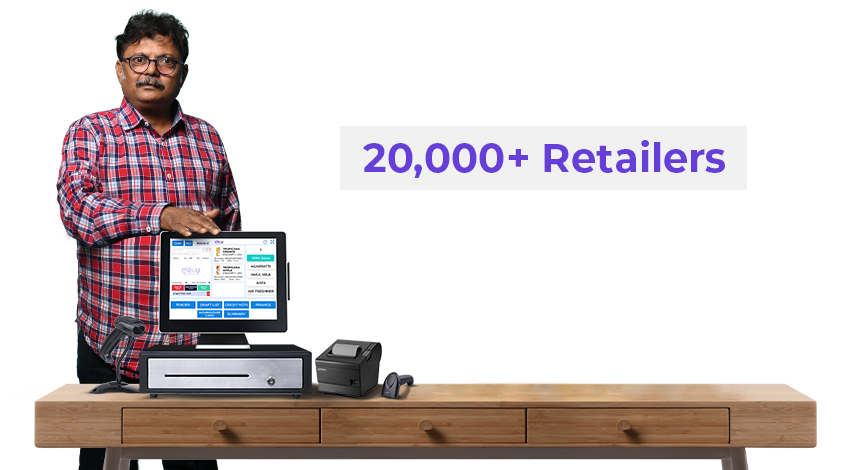 er4u retailer at his billing counter with touch POS, cash drawer, receipt printer and barcode scanner — 20,000+ retailers